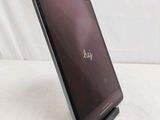 the dell laptop is sitting on a stand on a white surface
