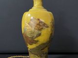 an image of a yellow vase with a bird painted on it