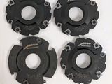 a set of four wheel hubs on a white surface
