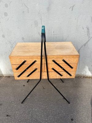 two wooden drawers with black handles and a blue handle on them