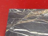 a black and white marble slab on a red surface