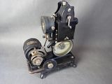 an old fashioned movie projector sitting on a table