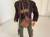 a figurine of a man with a hat and a bag