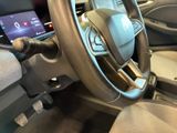 a steering wheel and dashboard of a car with a touch screen