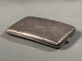 a silver cigarette case sitting on a table