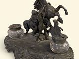 a bronze statue of a man on a horse