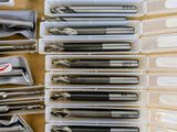 many different types of pens and pencils in a box