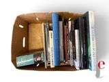many books in a cardboard box on a white background