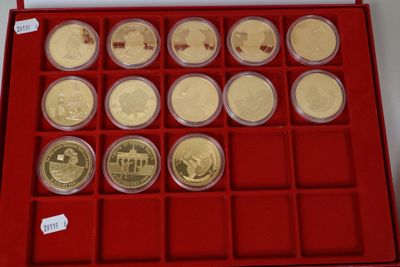 the red box holds twelve gold coins with a red lid