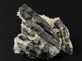 un gros plan d'un morceau de roche parsemé de cristaux sur fond noir