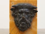 a statue of a man with a beard and a hat on a table