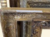 a close up of a mirror with a gold frame on it