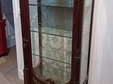a display case with a glass door in the corner of the room