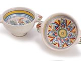 two bowls and a spoon sitting next to each other