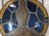 a picture of a stained glass plate on a shelf