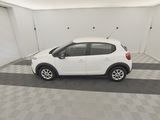 the small white car is parked in a clean garage