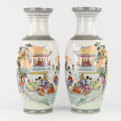 pair of chinese vases with asian scenes on them on a white background
