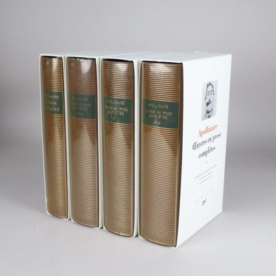 three books in a white box on a table with a gray background