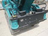 a blue machine that is sitting in the dirt