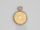 an old gold pocket watch with a chain on a white surface
