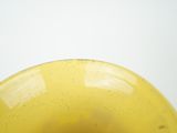 a yellow bowl that is sitting on a table