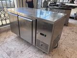 a stainless steel counter with two doors on the side of it