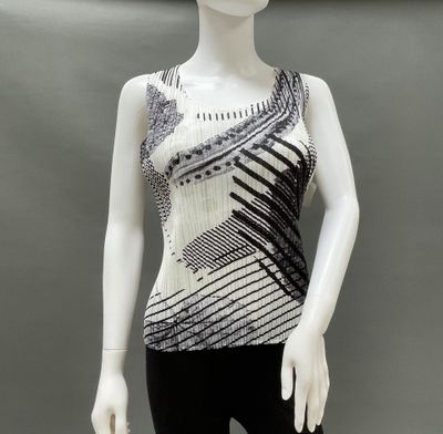 a mannequin wearing a black and white top and black pants
