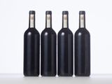 three bottles of wine are lined up in a row on a table