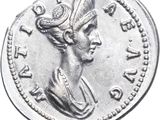 a close up of a silver coin with a woman ' s head on it