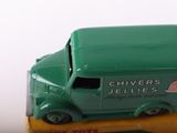 a green toy truck that is sitting on top of a yellow box