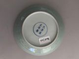a blue and white plate with a chinese writing on it