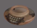 a small vase with a design on it sitting on a table