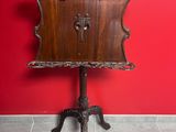 a wooden table with a clock on it in a red room