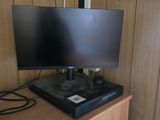 a flat screen tv sitting on top of a wooden cabinet