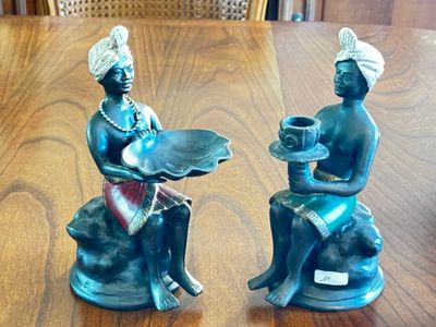 two figurines that are sitting on a table