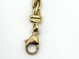 a gold chain with a dog charm on it