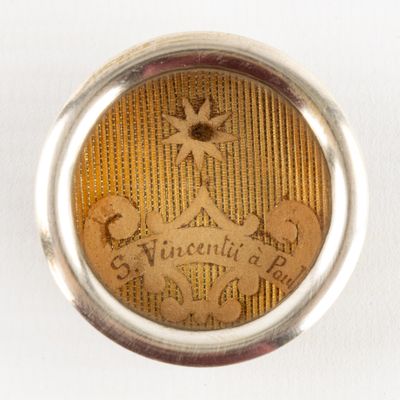 an image of a close up of a silver ring with a picture of a person on it