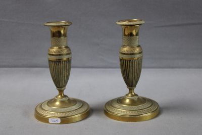 pair of antique brass candlesticks on a white background