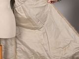 someone is holding a piece of cloth over a mannequin ' s torso