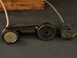 two old telephones sitting next to each other on a table