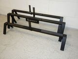 a black bench that is in a room with a white brick wall