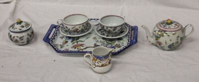 a tray with a tea set on it and a tray with cups and saucers