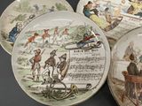 three plates with different designs on them sitting on a table