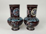 two vases that are sitting on a white surface