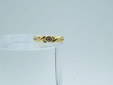 a gold ring with a diamond in it sitting on a glass