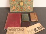 several old books are sitting on a table next to a box