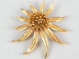 yellow gold plated flower brooch with pearls in the center