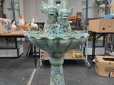 a statue of two birds sitting on top of a birdbath