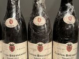 six bottles of wine are wrapped in plastic on a table