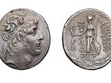 a silver coin with an image of a woman and a man on it